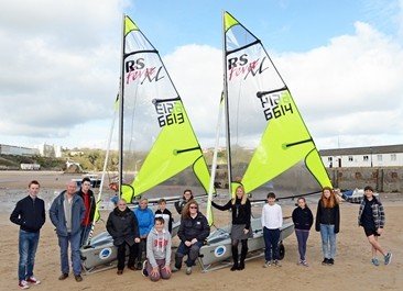 Sara Andrew, PR and Communications Executive at the Port, with Tenby Sailing Club’s new racing dinghies