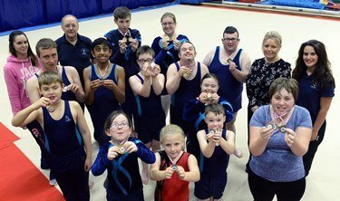 Anna Malloy, PR and Communications Manager at the Port, with members of Pembrokeshire Special Needs Gymnastics Club displaying their medals